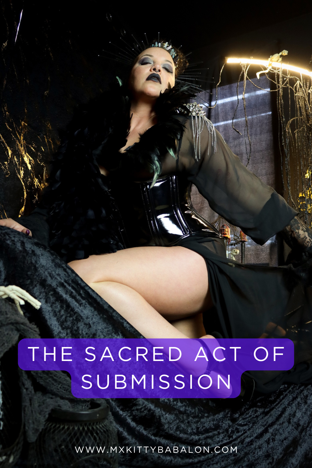 Mx Babalon poses on a velvet throne in crown like a dark goddess